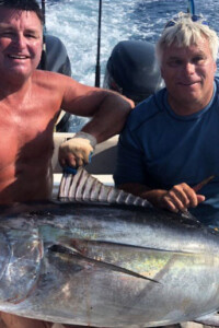 2 men with big fish on a charter boat